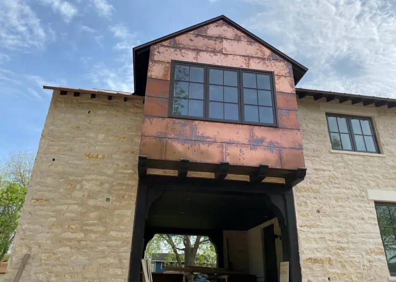 Copper metal panel facade on a stone building for Metal Roof Coating in Des Moines